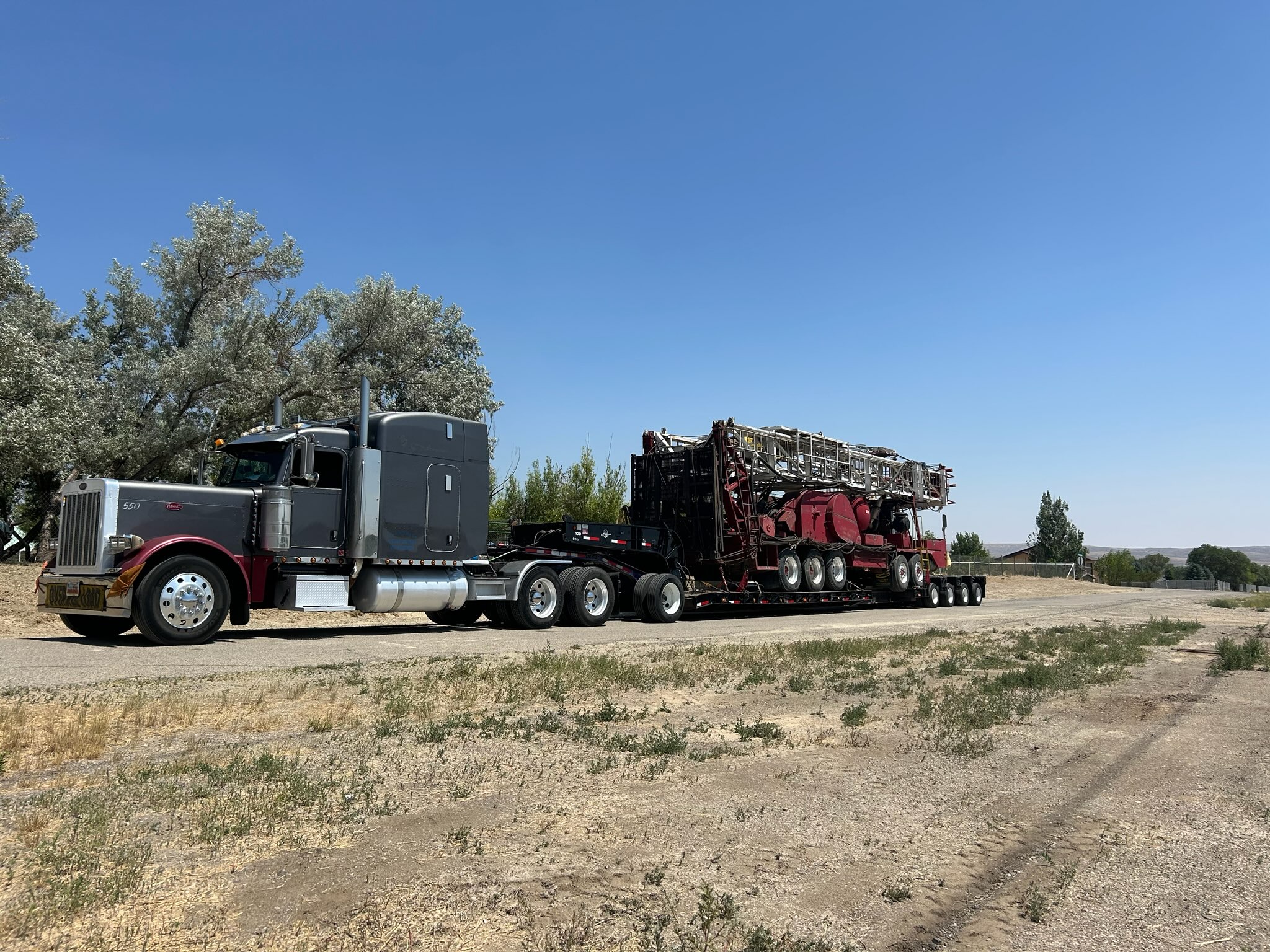 Oversized crane being loaded on an RGN trailer.