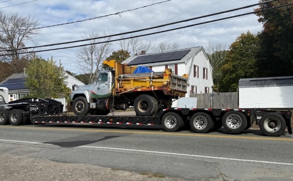 Hauling a 1979 Mack dump truck on a multi-axle RGN trailer.