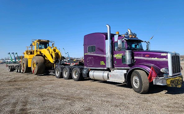 8 Axle Beam Trailer transporting a 126,000 lbs Caterpillar