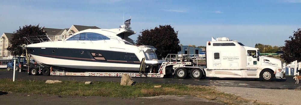 White and blue huge beautiful Yacht being transported for a White truck, Boat Transport Montana