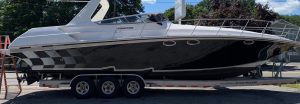 Boat-Transport-New-Jersey White and Blur Yacht on a trailer being transported, Boat Transport New Jersey
