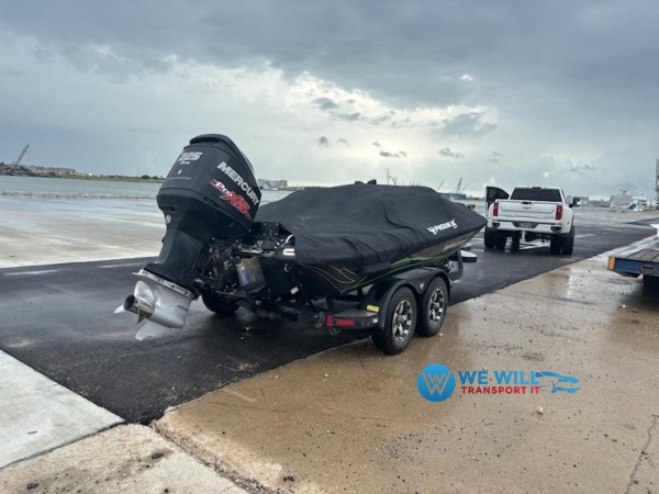 Boat on a dual-axle trailer being prepared to be towed by a pickup truck from Grand Rapids, Michigan to Duluth, Minnesota.