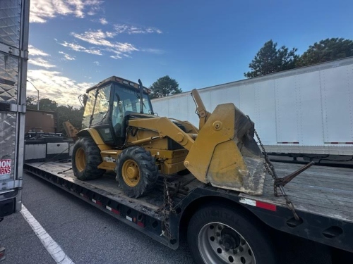 Shipping a Caterpillar 430D Backhoe on lowboy trailer.
