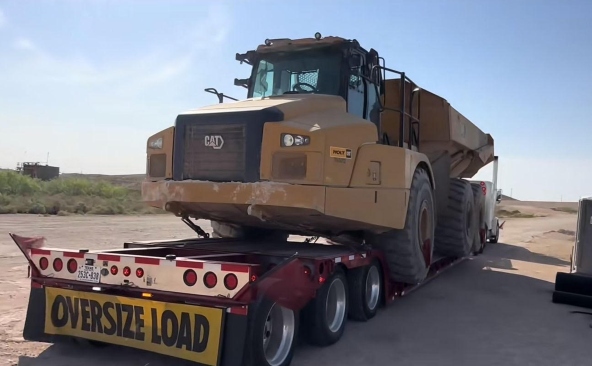 Hauling a caterpillar 745 articulated truck.
