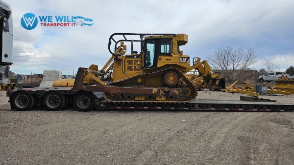 Caterpillar D6T track-type tractor transport on a lowboy trailer from Green Bay, Wisconsin to Missoula, Montana
