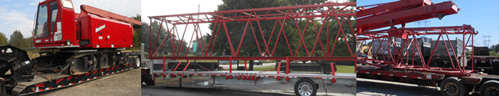 3 red cranes on trucks ready to be tranported