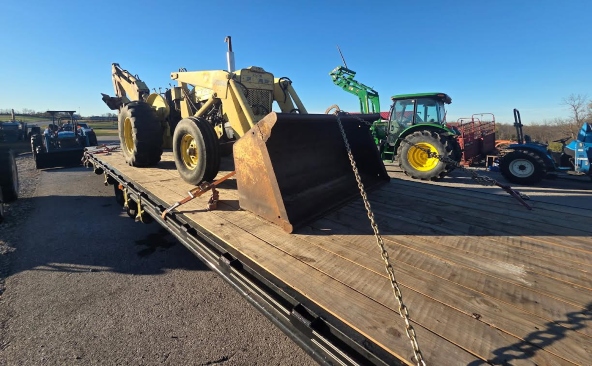 Transporting a Ford 4500 Backhoe loaded on a 40ft hotshot with mega ramps.
