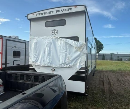 Forest River Sierra Destination Trailer attached to a pickup truck for transportation.