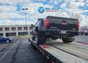 GMC Sierra 3500 HD Denali transport on a flatbed car hauler trailer.