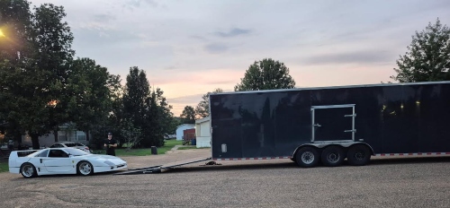 Pontiac Fiero Kit car going on loading ramp to go inside a enclosed trailer for transport.