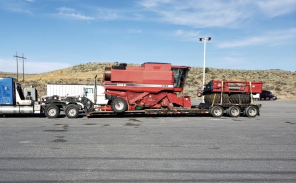 Hauling a Case IH 2388 Axial-Flow combine harvester on a RGN trailer.