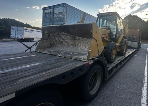 Hauling a Caterpillar 430D Backhoe on Lowboy trailer.