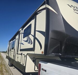 Hauling a Forest River Wildwood Heritage Glen fifth-wheel RV being pulled by a pickup truck.