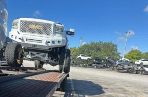 Hauling a GMC Sierra 2500HD Hauling a GMC Sierra 2500HD on two-car wedge trailer.