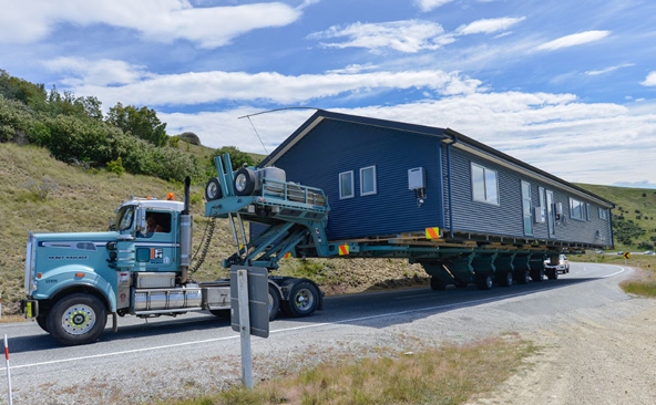 Hauling a Mobile Home with a specialized hydraulic modular trailer.