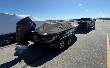 Hauling a Ranger bass boat using a hitch pulled by a truck.