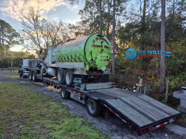Hauling a Septic Truck on a step deck trailer from Dayton, Ohio to Providence, Rhode Island.