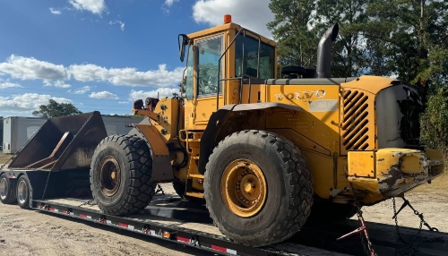 Hauling a Volvo wheel loader on a lowboy trailer.