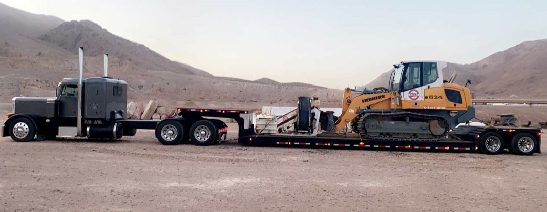 Hauling a Liebherr L 534 wheel loader on a RGN trailer.