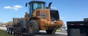Case Wheel loader being transported on a lowboy trailer.