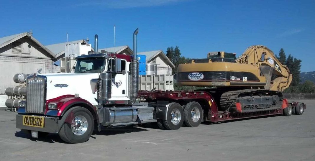 Hauling a Caterpillar 330C excavator on a lowboy trailer.