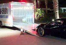 Reliable Auto Transport Nationwide Company Huge enclosed car transport trailer and a Ferrari car ready to be on the trailer