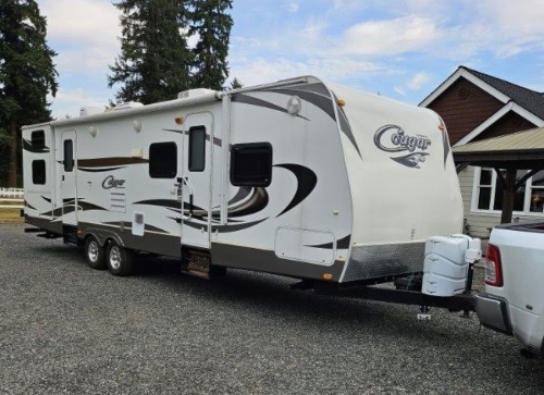 Transporting a Keystone Cougar hitched to a pickup truck.