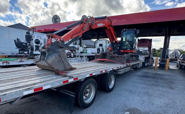 Transporting a Kubota KX080-4 excavator on a step deck trailer.
