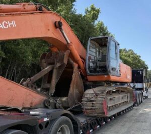 Moving a Hitachi Excavator on a RGN trailer.