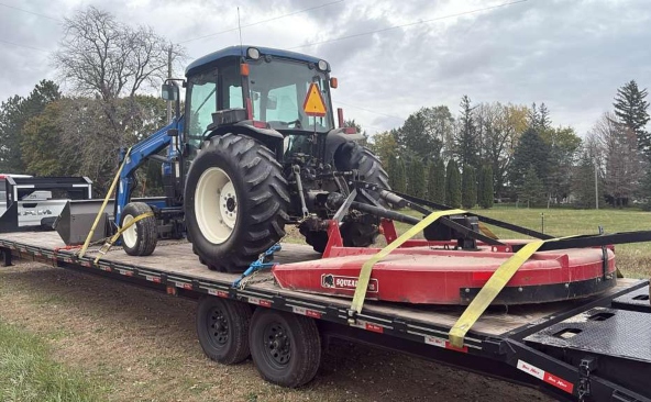 Moving a New Holland Workmaster utility tractor on a hotshot trailer.