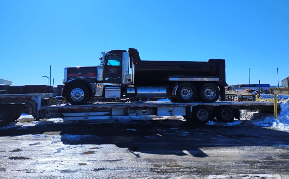 Moving a Peterbilt dump truck on a step deck trailer.