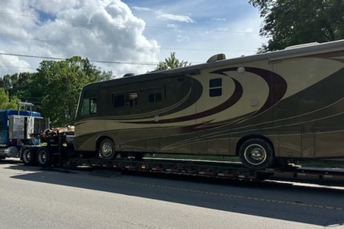 Hauling a Newmar RV on a lowboy trailer.