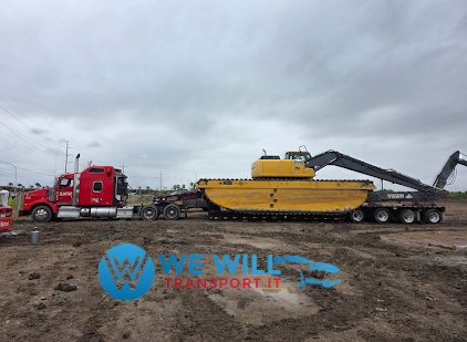 Transporting an oversize excavator on a 7-axle RGN lowboy trailer.