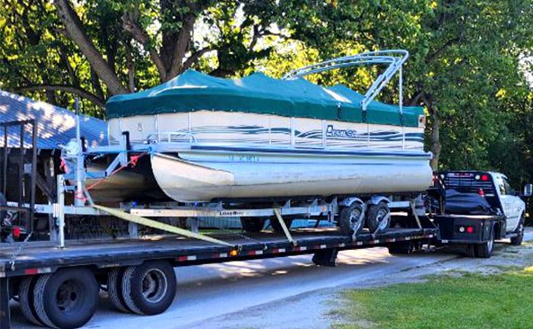 Hauling a Pontoon Boat and Golf Cart on a trailer.