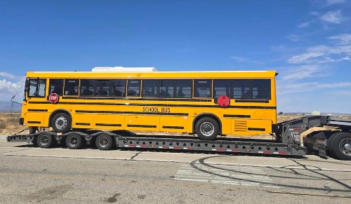 Shipping a School Bus on a RGN trailer.