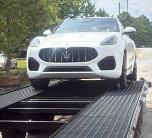 Shipping a Maserati Grecale on a flatbed car hauler trailer.