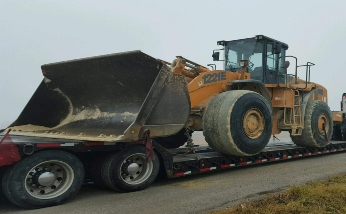 Transporting a CASE 1221E wheel loader on a lowboy trailer.