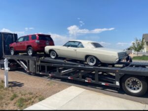 Transporting a Toyota RAV4 and Buick Rivera Transporting a Toyota RAV4 and Buick Rivera on a two-car open wedge trailer.