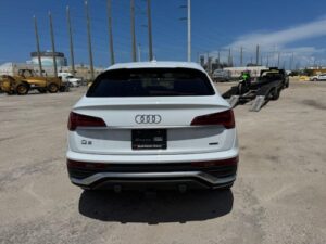 White Audi Q5 Transport Transporting a white Audi Q5 on a gooseneck wedge car hauler trailer.