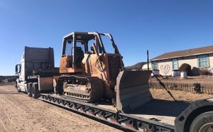Heavy machinery on a flatbed trailer - equipment hauling