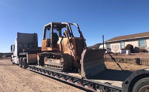 Heavy machinery on a flatbed trailer - equipment hauling