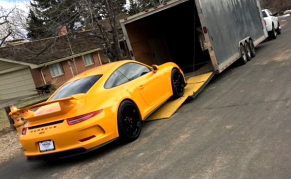 Transporting a Porsche in a enclosed trailer.