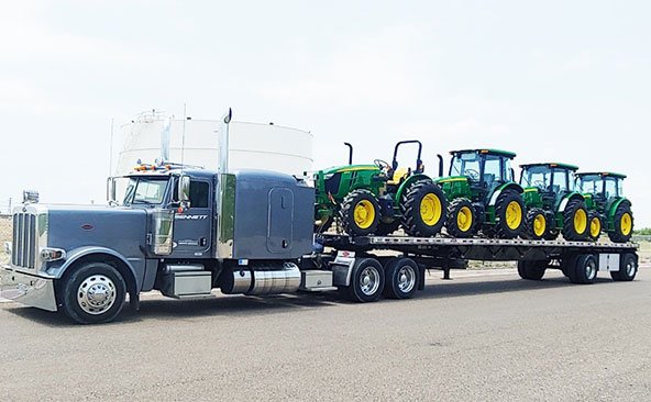 shipping 4 Holland tractors using flatbed truck trailer